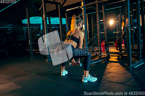 Image of The female athlete training hard in the gym. Fitness and healthy life concept.