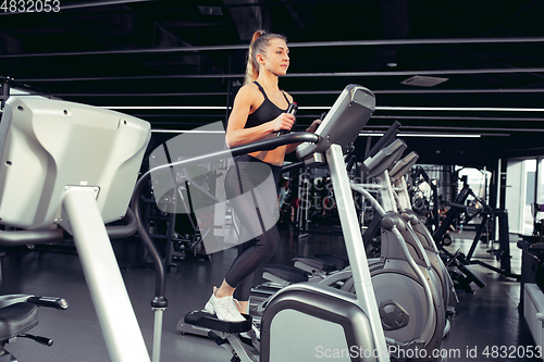 Image of The female athlete training hard in the gym. Fitness and healthy life concept.