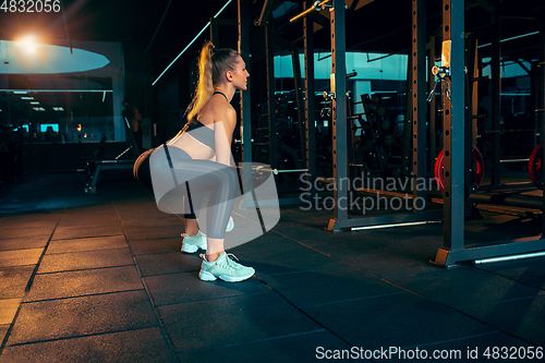 Image of The female athlete training hard in the gym. Fitness and healthy life concept.