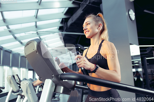 Image of The female athlete training hard in the gym. Fitness and healthy life concept.
