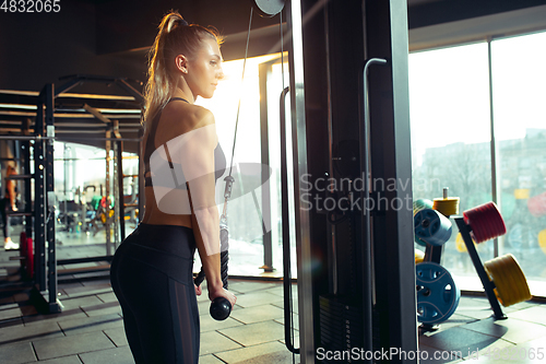 Image of The female athlete training hard in the gym. Fitness and healthy life concept.