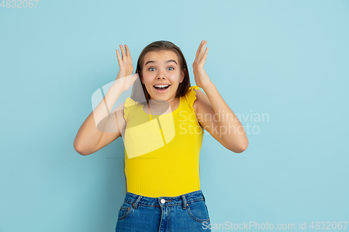 Image of Caucasian teen girl portrait isolated on blue studio background