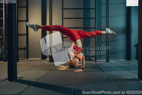 Image of The female athlete training hard in the gym. Fitness and healthy life concept.