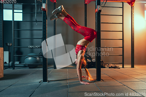 Image of The female athlete training hard in the gym. Fitness and healthy life concept.