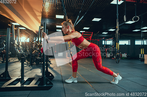 Image of The female athlete training hard in the gym. Fitness and healthy life concept.