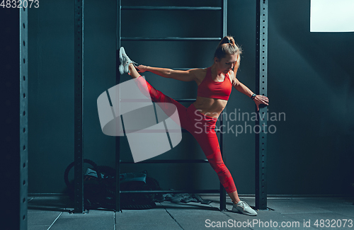 Image of The female athlete training hard in the gym. Fitness and healthy life concept.