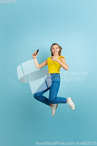 Image of Caucasian teen girl portrait isolated on blue studio background