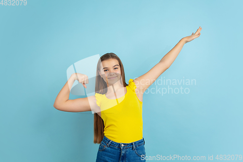 Image of Caucasian teen girl portrait isolated on blue studio background