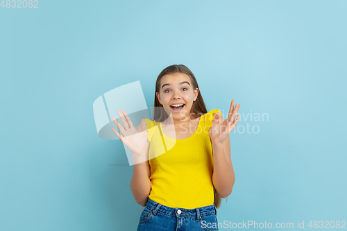 Image of Caucasian teen girl portrait isolated on blue studio background