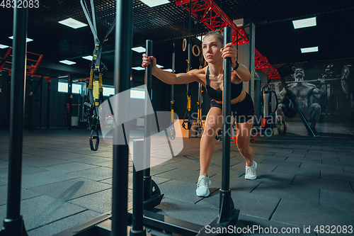 Image of The female athlete training hard in the gym. Fitness and healthy life concept.