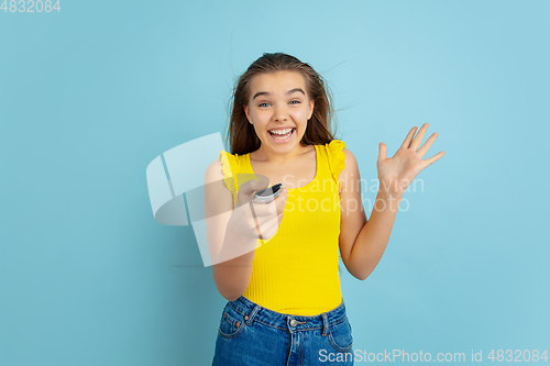 Image of Caucasian teen girl portrait isolated on blue studio background