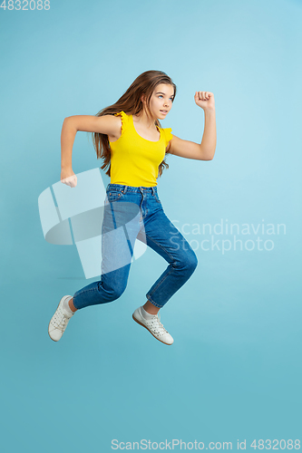 Image of Caucasian teen girl portrait isolated on blue studio background