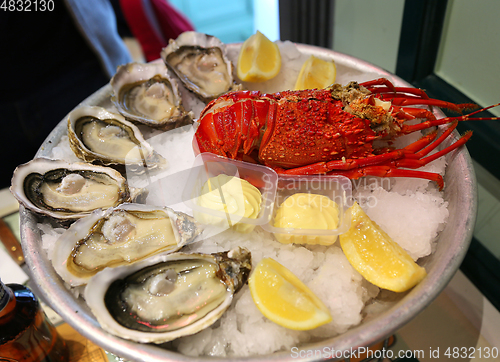 Image of Large dish with fresh seafood, oysters with lobster with lemon a