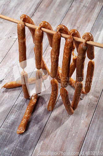 Image of Sausages On A Wooden Table