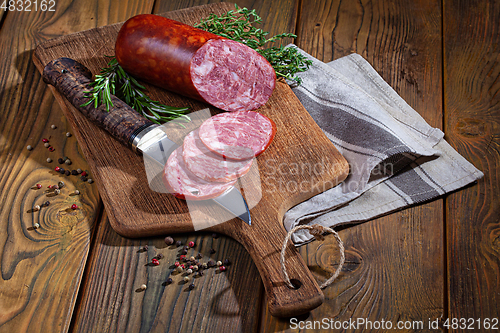 Image of Sausage And The Knife On An Old Wooden Desk