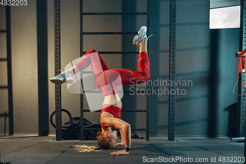 Image of The female athlete training hard in the gym. Fitness and healthy life concept.