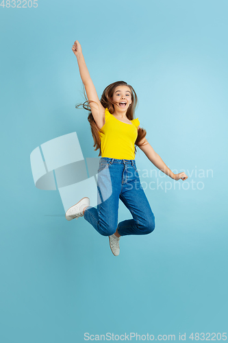 Image of Caucasian teen girl portrait isolated on blue studio background