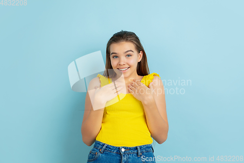 Image of Caucasian teen girl portrait isolated on blue studio background