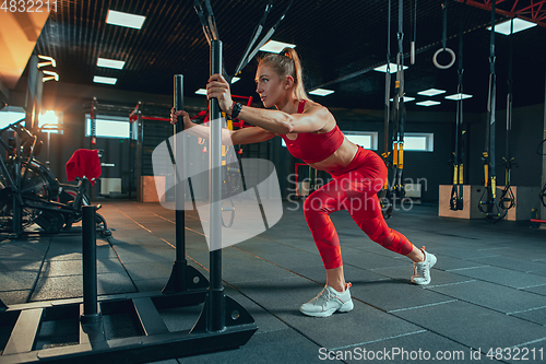 Image of The female athlete training hard in the gym. Fitness and healthy life concept.