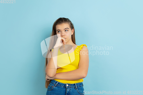 Image of Caucasian teen girl portrait isolated on blue studio background