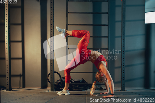 Image of The female athlete training hard in the gym. Fitness and healthy life concept.