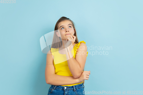 Image of Caucasian teen girl portrait isolated on blue studio background