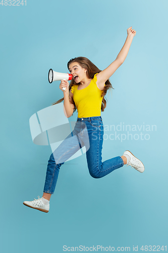 Image of Caucasian teen girl portrait isolated on blue studio background