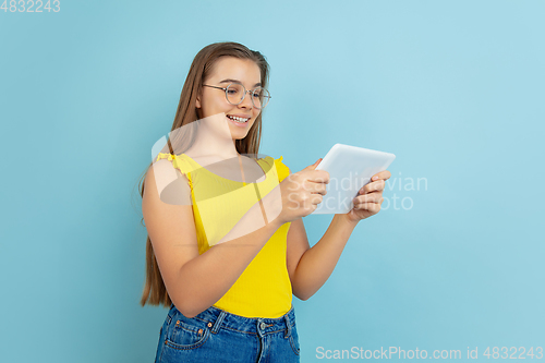 Image of Caucasian teen girl portrait isolated on blue studio background