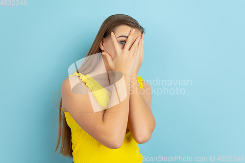 Image of Caucasian teen girl portrait isolated on blue studio background