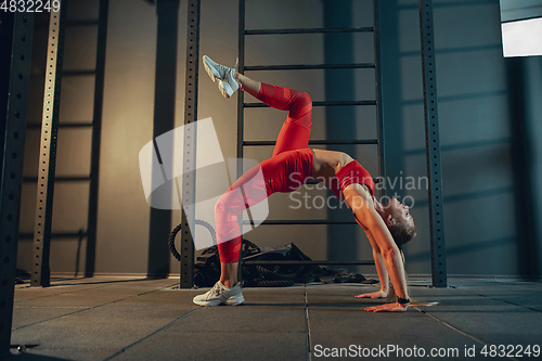 Image of The female athlete training hard in the gym. Fitness and healthy life concept.