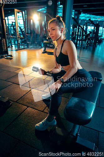 Image of The female athlete training hard in the gym. Fitness and healthy life concept.