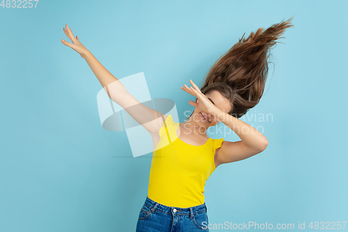 Image of Caucasian teen girl portrait isolated on blue studio background