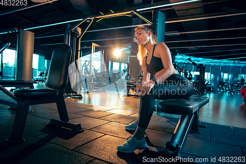 Image of The female athlete training hard in the gym. Fitness and healthy life concept.