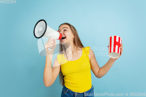 Image of Caucasian teen girl portrait isolated on blue studio background