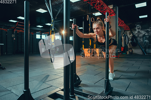 Image of The female athlete training hard in the gym. Fitness and healthy life concept.