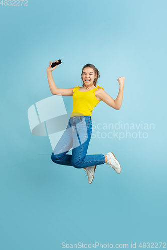 Image of Caucasian teen girl portrait isolated on blue studio background