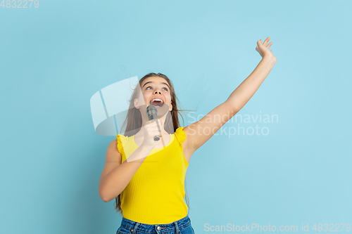 Image of Caucasian teen girl portrait isolated on blue studio background