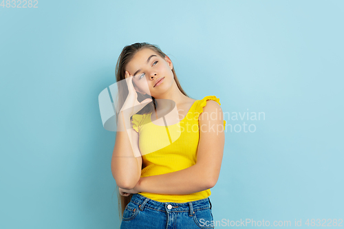 Image of Caucasian teen girl portrait isolated on blue studio background