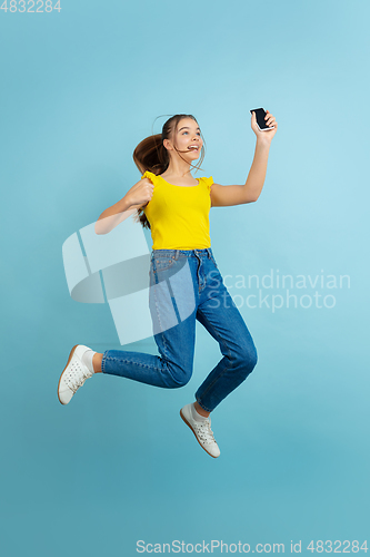 Image of Caucasian teen girl portrait isolated on blue studio background