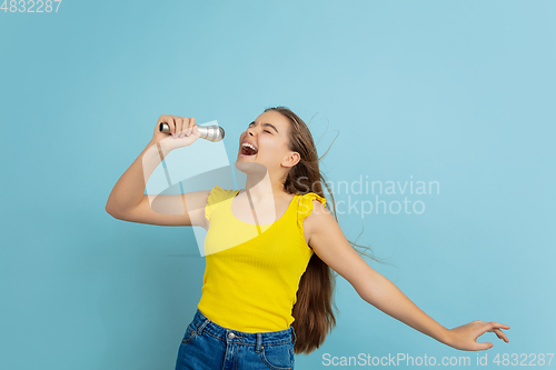 Image of Caucasian teen girl portrait isolated on blue studio background