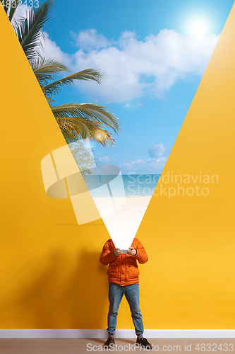 Image of Young caucasian man with smartphone, opening world using his gadget