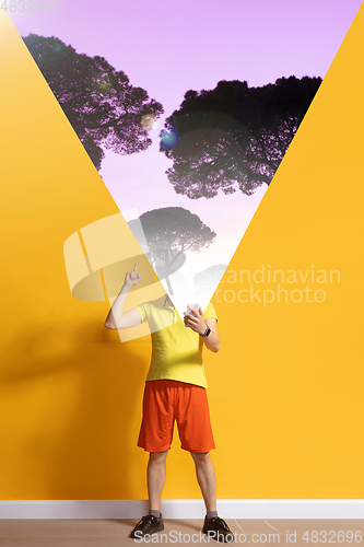 Image of Young caucasian man with smartphone, opening world using his gadget