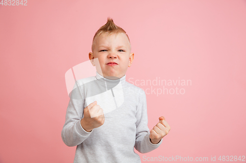 Image of Happy boy isolated on pink studio background. Looks happy, cheerful, sincere. Copyspace. Childhood, education, emotions concept