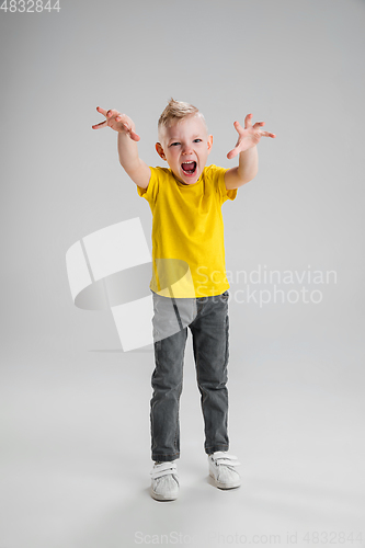 Image of Happy boy isolated on white studio background. Looks happy, cheerful, sincere. Copyspace. Childhood, education, emotions concept