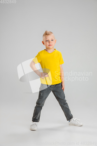 Image of Happy boy isolated on white studio background. Looks happy, cheerful, sincere. Copyspace. Childhood, education, emotions concept