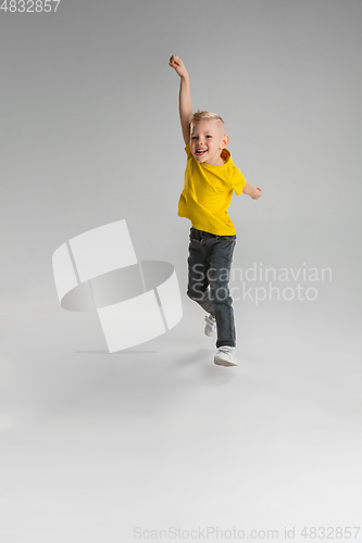 Image of Happy boy isolated on white studio background. Looks happy, cheerful, sincere. Copyspace. Childhood, education, emotions concept