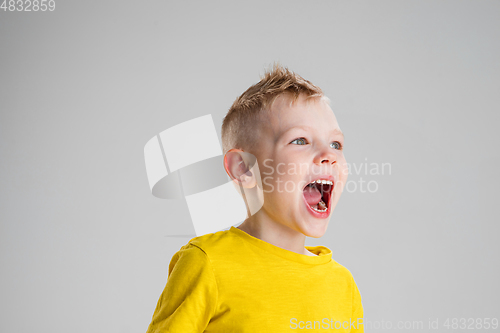 Image of Happy boy isolated on white studio background. Looks happy, cheerful, sincere. Copyspace. Childhood, education, emotions concept