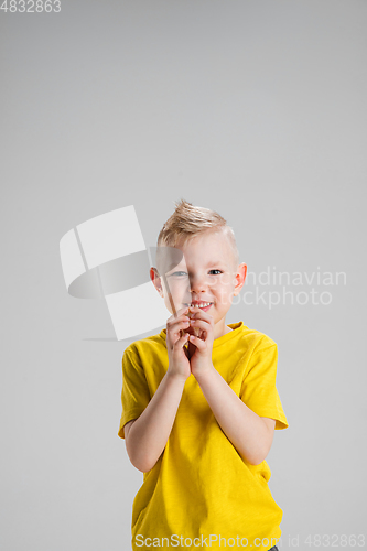 Image of Happy boy isolated on white studio background. Looks happy, cheerful, sincere. Copyspace. Childhood, education, emotions concept