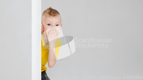 Image of Happy boy isolated on white studio background. Looks happy, cheerful, sincere. Copyspace. Childhood, education, emotions concept