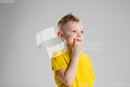 Image of Happy boy isolated on white studio background. Looks happy, cheerful, sincere. Copyspace. Childhood, education, emotions concept